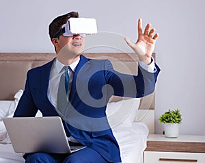 Businessman wearing a virtual reality headset in the bedroom