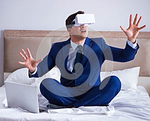 Businessman wearing a virtual reality headset in the bedroom