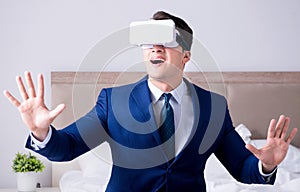 Businessman wearing a virtual reality headset in the bedroom