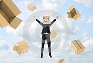 Businessman wears box on his head with funny face, lifts hands up and flying away
