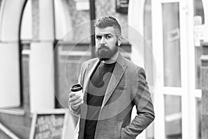 Businessman well groomed appearance enjoy coffee break out of business center. Relax and recharge. Man bearded hipster