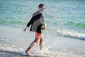 businessman in wet suit at the beach. Summer business dreams. Successful businessman on vacation. Businessman in suit