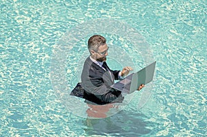 businessman in wet suit in swim pool. Remote working. Summer business dreams. successful man. Businessman in suit with