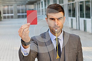 Businessman with whistle and red card