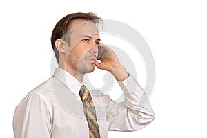 Businessman in white shirt talks on phone