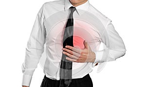 Businessman in a white shirt and tie holding his chest. Pain in
