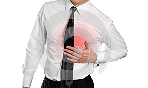 Businessman in a white shirt and tie holding his chest. Pain in photo