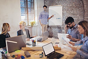 Businessman At Whiteboard Giving Presentation