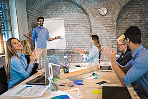 Businessman At Whiteboard Giving Presentation