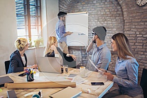 Businessman At Whiteboard Giving Presentation