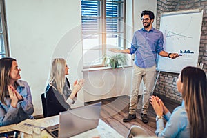 Businessman At Whiteboard Giving Presentation