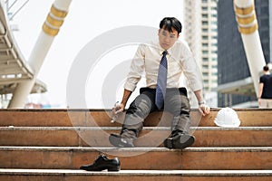 Businessman who are tired or stressed sit on the stairs
