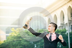 Businessman wins a trophy. Top salesperson concept