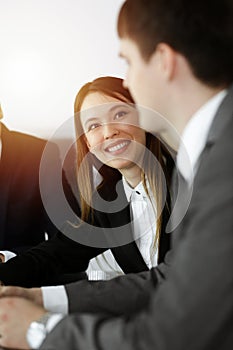 Businessman and woman with colleague sitting and working at the desk. Business people discussing questions at meeting in