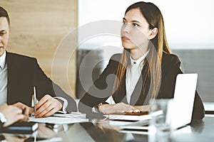 Businessman and woman with colleague sitting and working at the desk. Business people discussing questions at meeting in