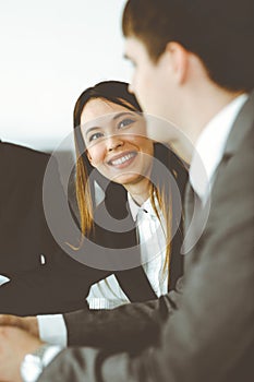 Businessman and woman with colleague sitting and working at the desk. Diverse business people discussing questions at
