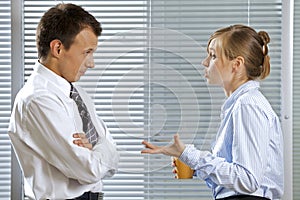 Businessman and woman in conversation at office