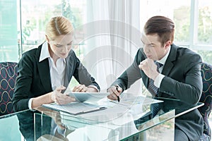 Businessman and woman discussing in office