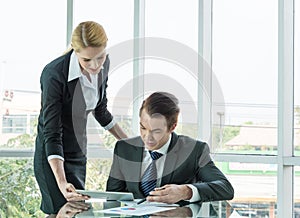 Businessman and woman discussing in office