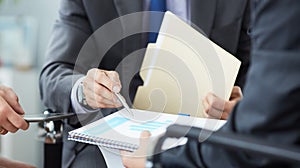 Businessman and woman discussing on stock market charts in office. Men in a suit hold a clipboard with financial charts.