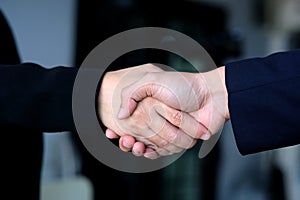 Businessman and woman handshake at office, business cooperation, success in business concept