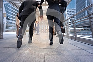 businessman and woman hurry up and running in business city street for rush hour, motion blur background