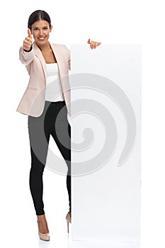 Businessman woman presenting a billboard and making the ok sign