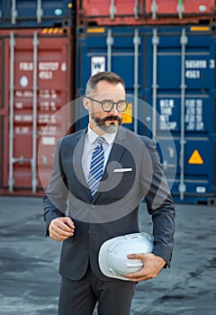 Businessman  work at Container cargo site check up goods in container. Manager checking on shipping containers. Logistics and ship