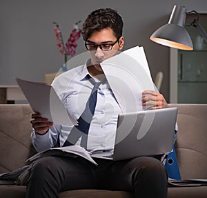 Businessman workaholic working late at home