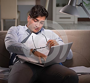 Businessman workaholic working late at home