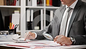 Businessman working and calculating, reads and writes reports. Office employee, table closeup. Business financial accounting
