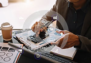 Businessman working on calculator to calculate financial data report, accountancy document and laptop computer at office, business