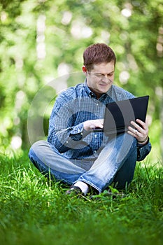 Businessman working in the city park.