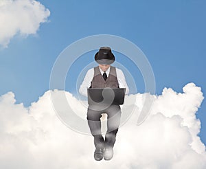 Businessman working on a cloud.