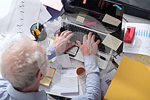 Businessman working on a cluttered and messy desk