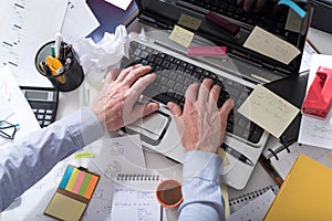 Businessman working on a cluttered and messy desk