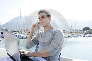 Businessman working with computer on a boat