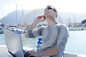 Businessman working with computer on a boat