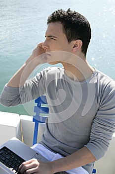 Businessman working with computer on a boat