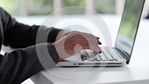 Businessman Working on Computer Laptop on Table in Office. Cropped Image of Typing Keyboard.Slow Motion