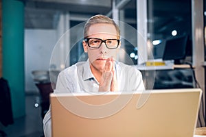 Businessman working with computer late at night.