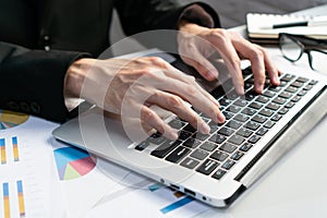 Businessman working with computer in office. Man work on laptop at home. Work from home, business and technology concept. Closeup