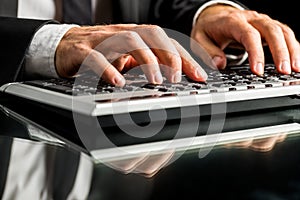 Businessman working on computer by typewriting photo