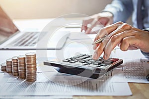 businessman working on desk with using calculator for calculate finance and accounting