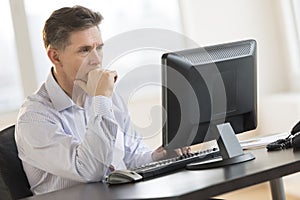 Businessman Working On Desktop Pc In Office