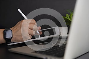 Businessman working on digital tablet and laptop computer on glass table