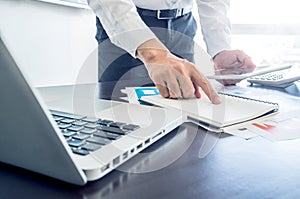 businessman working with digital tablet and laptop with financial business document.