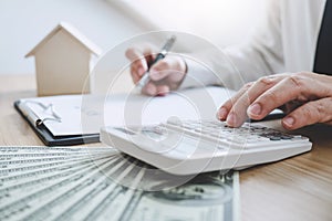 Businessman working doing finances and calculation cost of real