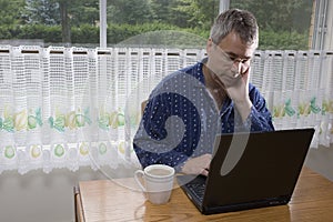 Businessman working from home in pajamas photo