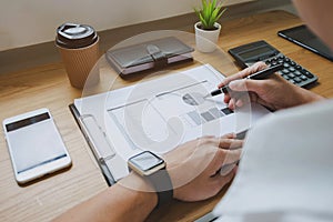 Businessman working with income statement document on the wood t